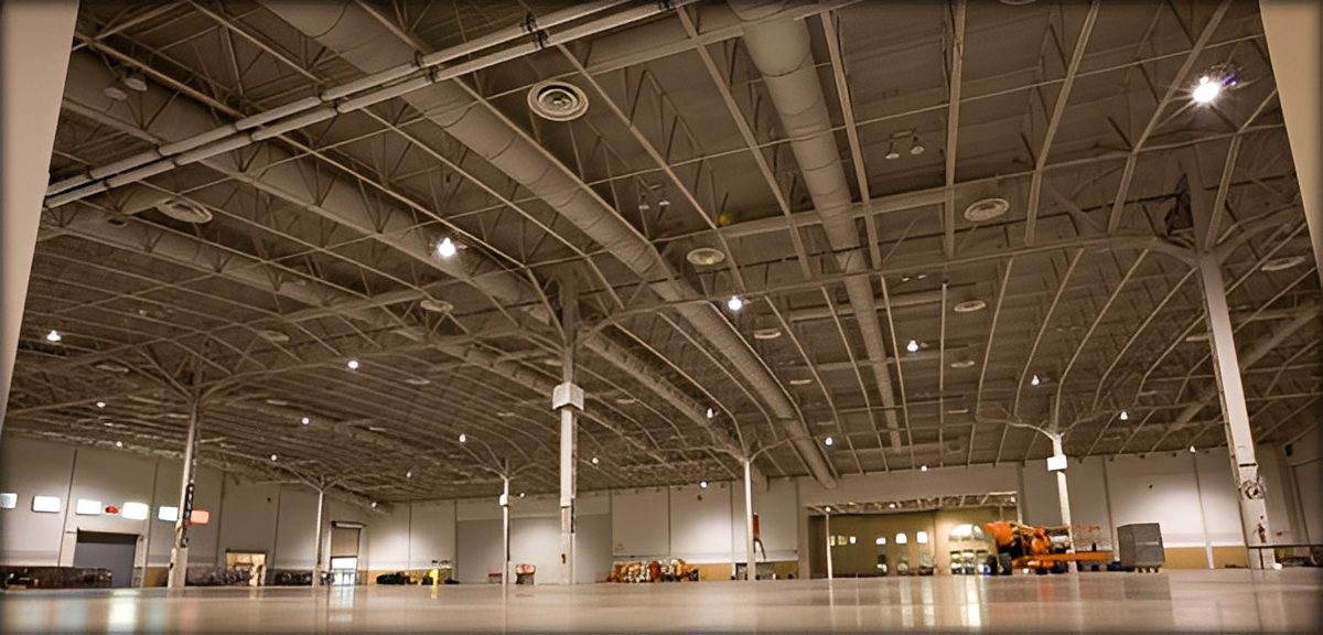 Empty industrial warehouse with high ceiling.