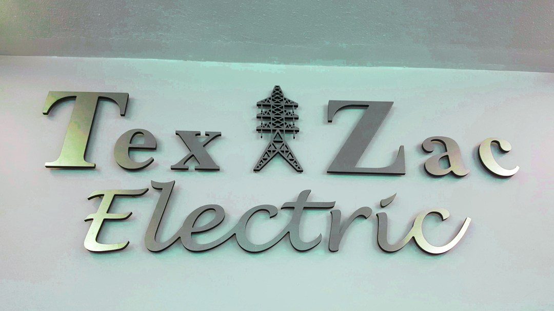 Tex Zac Electric sign on a wall.