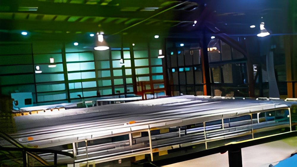 Indoor industrial space with large metal structure.